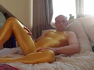Solo performer in shiny yellow spandex on webcam