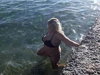Milf playing with her candy body on public beach