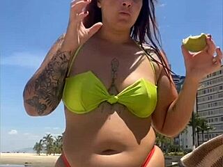 african wife flashing on beach with tight bikini